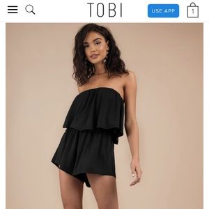 Tobi black strapless romper with flowy overlay